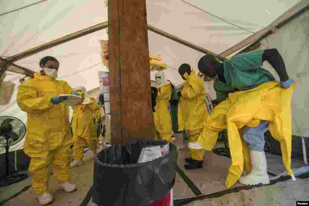 Medical staff working with Medecins Sans Frontieres (MSF) put on their protective gear before entering an isolation area at the MSF Ebola treatment center, in Kailahun, Sierra Leone, July 20, 2014. 