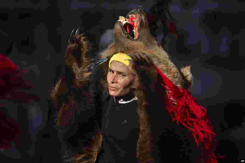 A person from northern Romania performs the bear dance Christmas and New Year's ritual in Bucharest, Romania, Dec. 25, 2021.