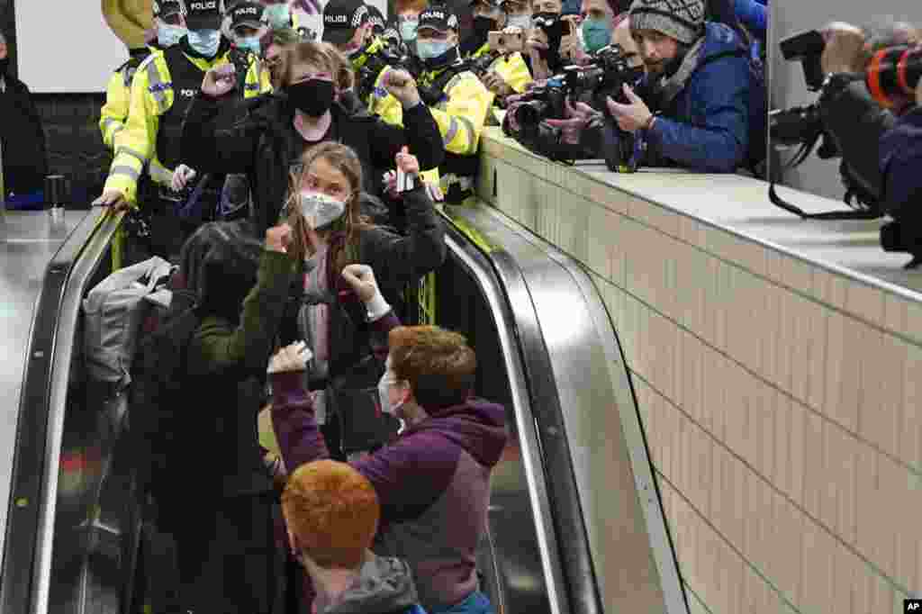 Climate activist Greta Thunberg, center, arrives at Central Railway station in Glasgow, Scotland, Oct. 30, 2021, ahead of the start of COP26.