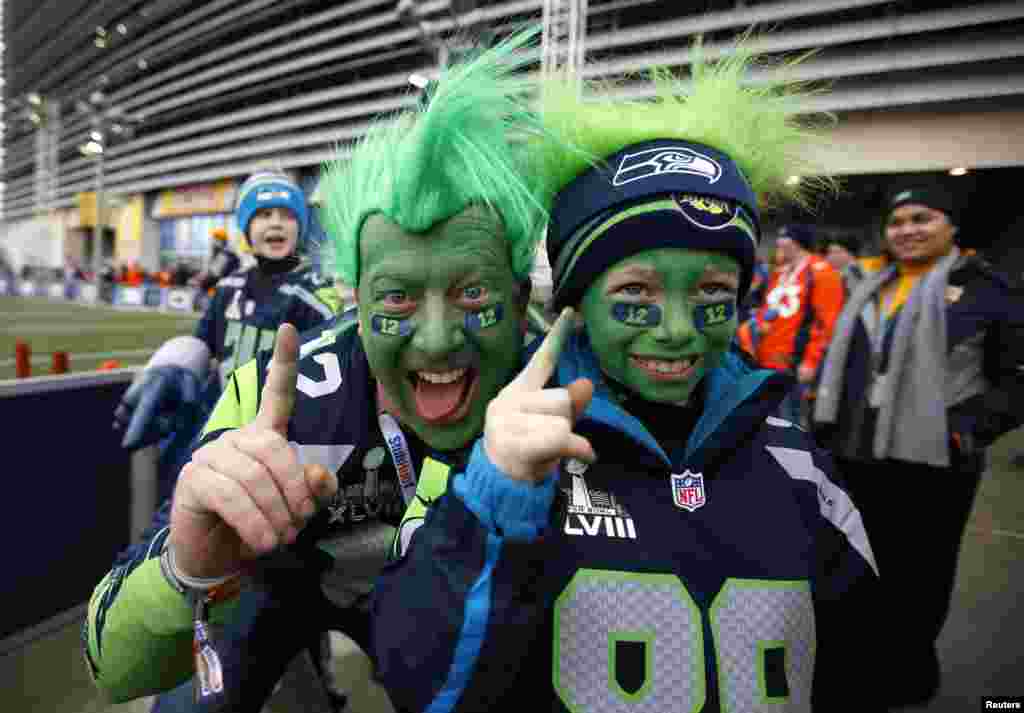 Seattle Seahawks fans Todd Gibson and his son Karsten pose outside the stadium before the start of the NFL Super Bowl XLVIII football game in East Rutherford, New Jersey, Feb. 2, 2014.