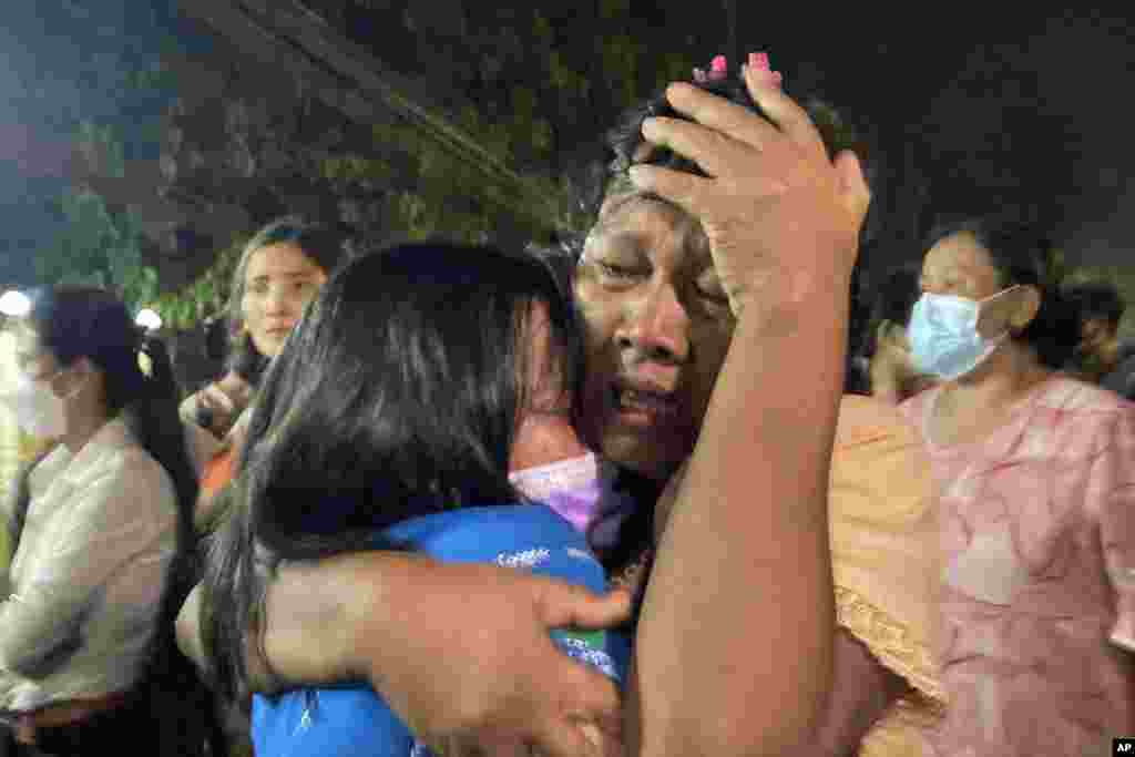 A mother reacts after her daughter, left, was released from Insein Prison in Yangon, Myanmar. Myanmar's government announced an amnesty for more than 5,600 people arrested for taking part in anti-coup protests. Over 1,000 people were freed from prisons around the country and charges against more than 4,000 others were suspended. 