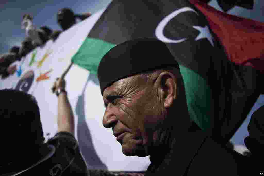 A Libyan man watches a protest against the Tripoli-based militias and supporting the new national army and the police corps in the Libyan capital.
