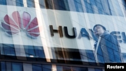 A man walks past a Huawei shop in Beijing, China, March 7, 2019. 