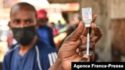 FILE - A health official prepares the Moderna Covid-19 vaccine during a Covid-19 vaccination drive in Nairobi, Kenya, Sep. 17, 2021. (Photo by Simon MAINA / AFP)