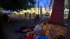 A small group of migrants waiting to seek asylum sleeps at the entrance to the Puerta Mexico international bridge in Matamoros, Mexico, June 28, 2019. 