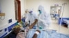 FILE — Medical staff wearing protective equipment attend to patients affected by COVID-19, on the Intensive Care Unit (ICU) of the Machakos County Level-5 hospital in Machakos, Kenya.