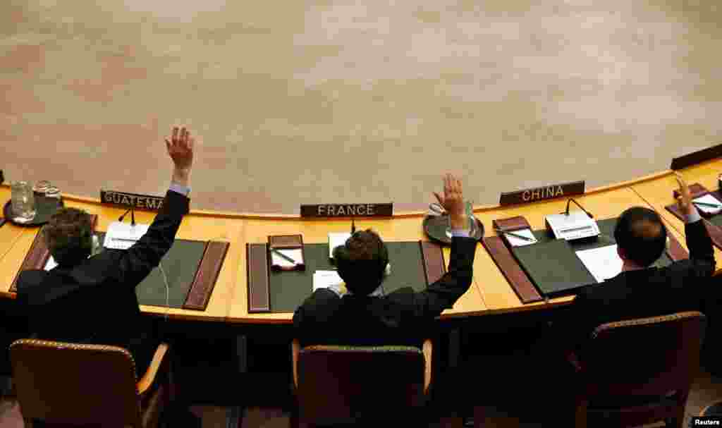 Members of the United Nations Security Council vote to tighten sanctions on North Korea at the United Nations Headquarters in New York, March 7, 2013.