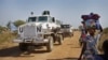 FILE - Displaced people are passed by a United Nations vehicle while walking toward a U.N. camp in Malakal, South Sudan, Dec. 30, 2013. The U.N. is now helping thousands of families in the state of Yei River displaced by months of fighting. 