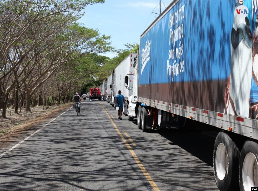 Los transportistas han dispuesto sus vehículos en fila mientras esperan para seguir camino.