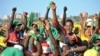 Supporters of presidential candidate John Magufuli of the ruling Chama Cha Mapinduzi party cheer at an election rally in Dar es Salaam, Tanzania, Oct. 23, 2015.