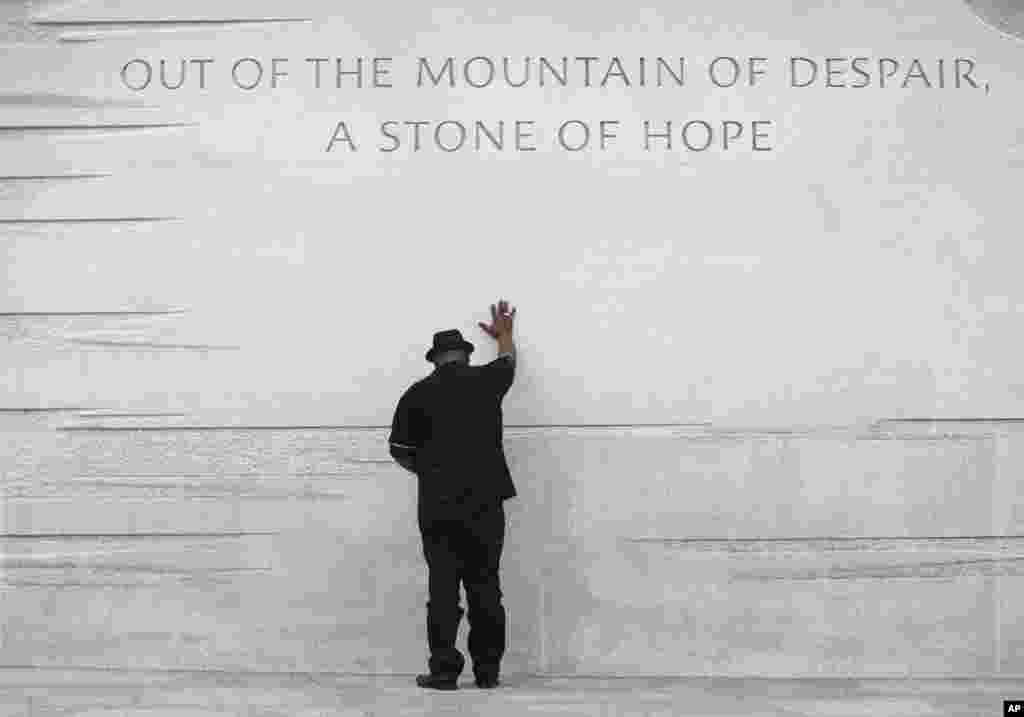 Rev. Bobby Turner places his hand on the Martin Luther King Jr. Memorial in Washington, Aug. 22, 2013.