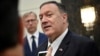 FILE - U.S. Secretary of State Mike Pompeo speaks to the media before departing from al-Bateen Air Base in Abu Dhabi, United Arab Emirates, Sept. 19, 2019, as U.S. special representative on Iran Brian Hook, left, listens. 