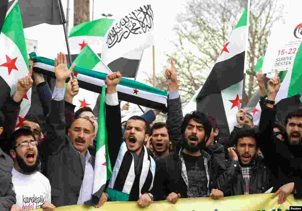 Demonstrators shout slogans during a protest against the government of Bashar al-Assad in Istanbul March 15, 2013.