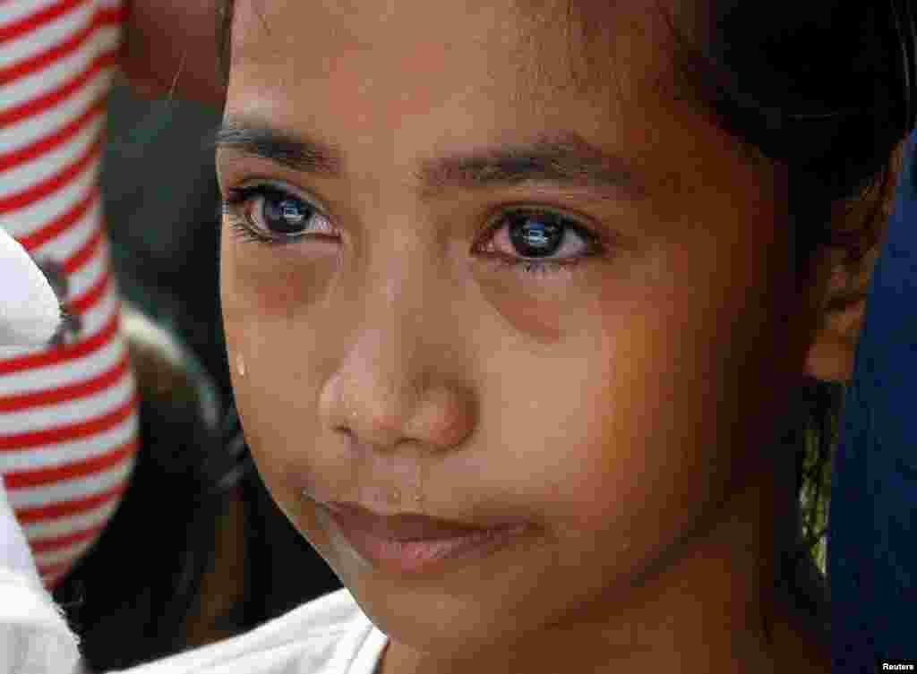 Lovely Batiancila weeps during the funeral of her father Vicente, whom police said was among five victims of drug related killings three weeks ago, in Navotas, Metro Manila in the Philippines.