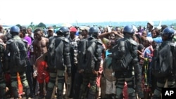 FILE - Displaced residents fleeing sectarian violence were cordoned off by military at the airport in Bangui, Central African Republic. 