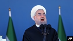 Iran's President Hassan Rouhani speaks at a military parade marking National Army Day in front of the mausoleum of the late revolutionary founder Ayatollah Khomeini, just outside Tehran, April 17, 2016.