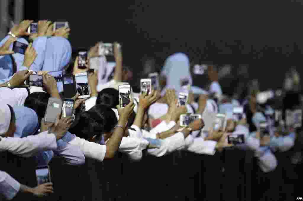 Nuns prepare to take photos of Pope Francis before he arrives for a meeting with the bishops of Myanmar at St. Mary's Cathedral in Yangon, Myanmar.