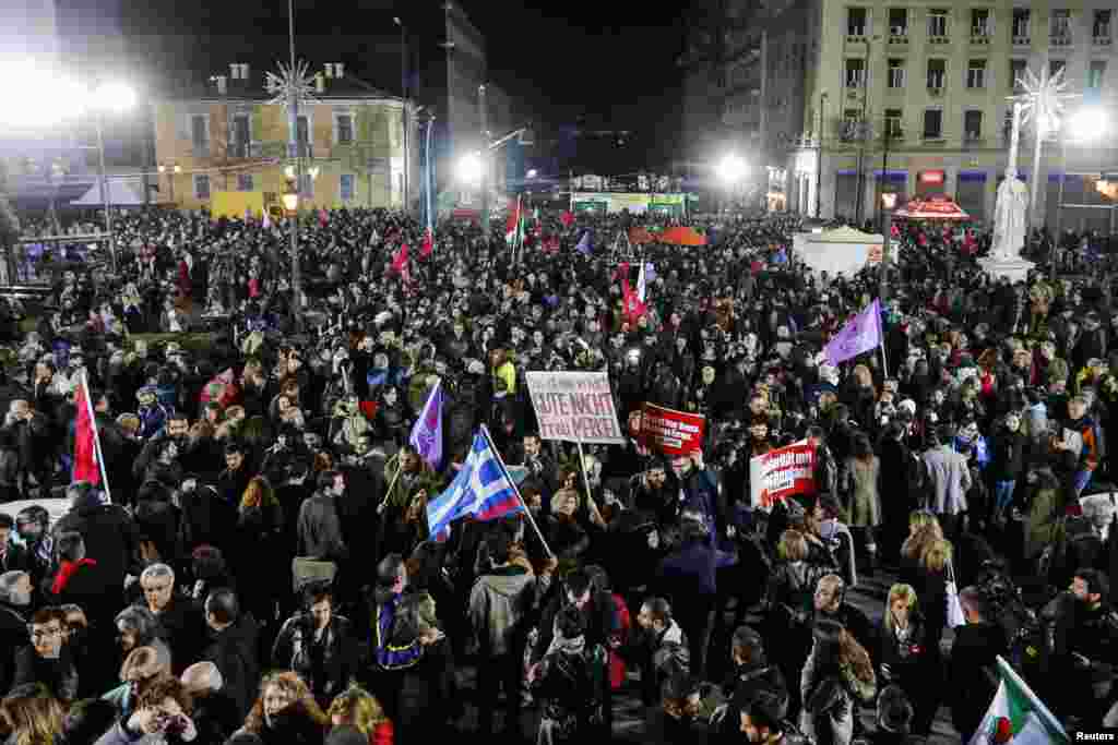 Supporters of the head of radical leftist Syriza party, Alexis Tsipras, celebrate after their leader won the election in Athens, Jan. 25, 2015.