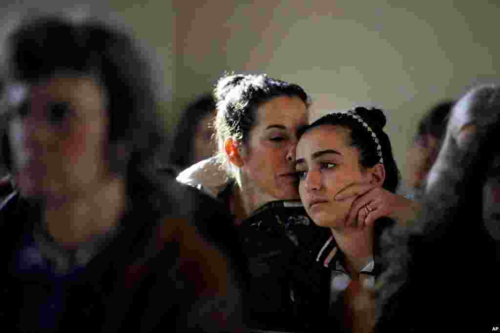 Elizabeth Bogdanoff, left, kisses her daughter Julia, 13, during a prayer service at St John's Episcopal Church on Dec. 15, 2012 in Newtown, Conn.