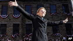 FILE - Sen. Elizabeth Warren, D-Mass., acknowledges cheers as she takes the stage during an event to formally launch her presidential campaign in Lawrence, Mass., Feb. 9, 2019.