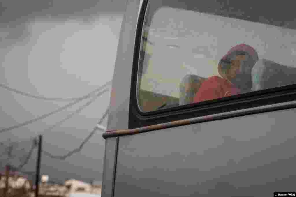 A man waits on the bus taking him from Souda camp to Vial camp in Chios.