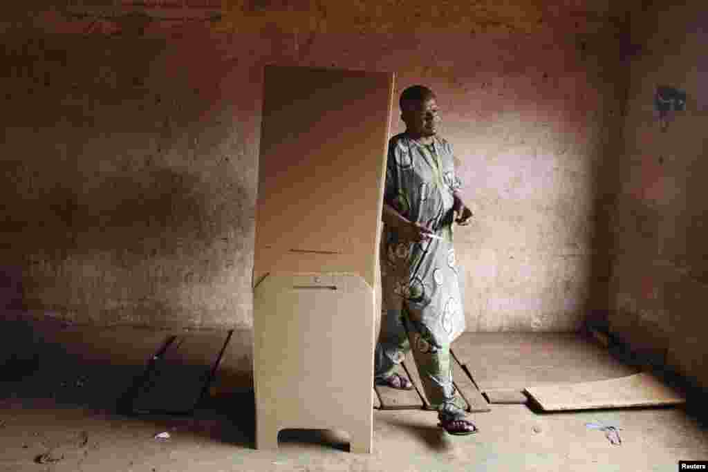 A man walks out of a voting booth during the second round of presidential elections, Bamako, August 11, 2013.