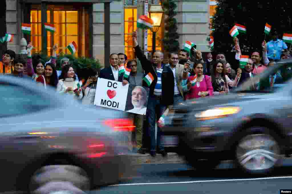 Supporters gather to greet India's Prime Minister Narendra Modi as he pays homage at the Mahatma Gandhi Statue in front of the Indian Embassy in Washington, Sept. 30, 2014.