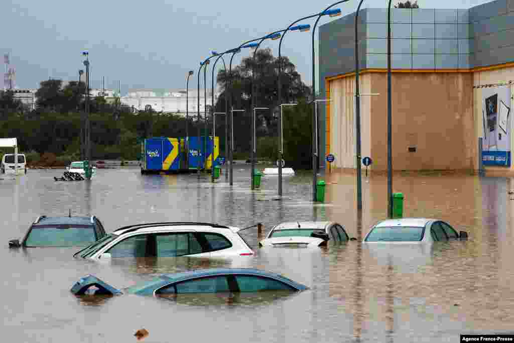 Cars submerge in a flooded parking lot outside a shopping center in Oman's capital Muscat. Bad weather has been affecting states around the Gulf, with several issuing weather warnings.