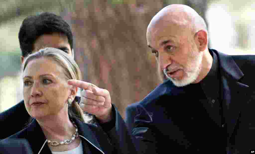 Clinton walks with Afghanistan President Hamid Karzai at the Presidential Palace in Kabul, July 7.