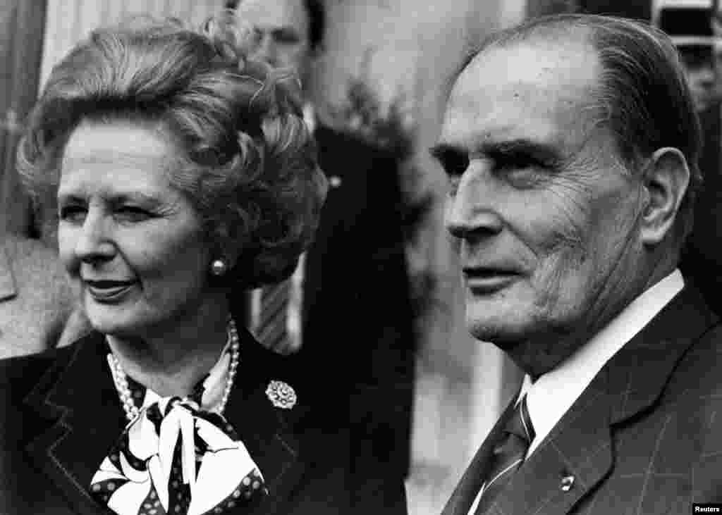 Then British Prime Minister Margaret Thatcher and French President Francois Mitterrand posed for the media after a meeting about nuclear arms control at the Chateau de Benouville in Normandy, western France, March 23, 1987.