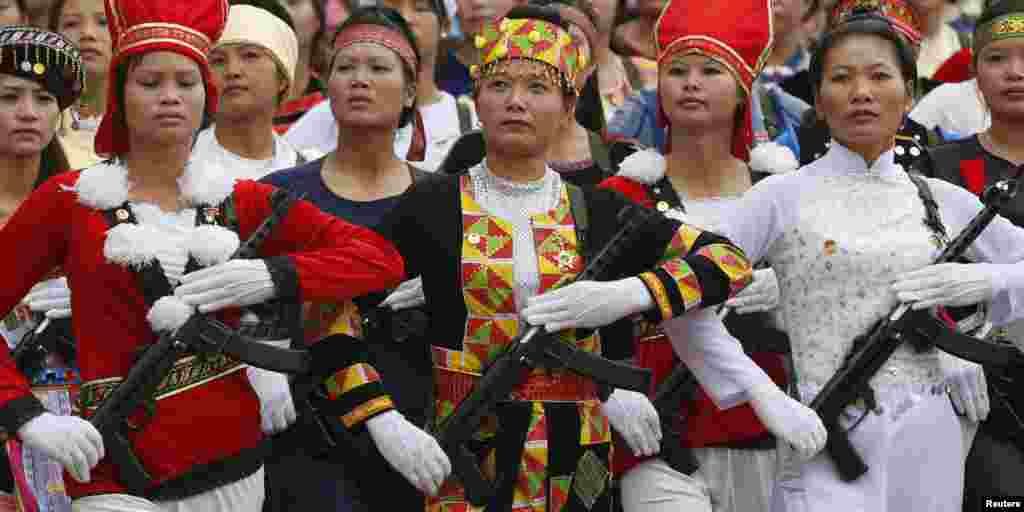 Vietnamese female militants, dressed in ethnic minorities costumes, hold WWII-era submachineguns while marching during the 60th anniversary celebrations of the Dien Bien Phu battle in the historic city. Viet Minh forces overran the French garrison in Dien Bien Phu on May 7, 1954 after a 56-day siege, forcing the French government to abandon its colonial rule in Indochina.