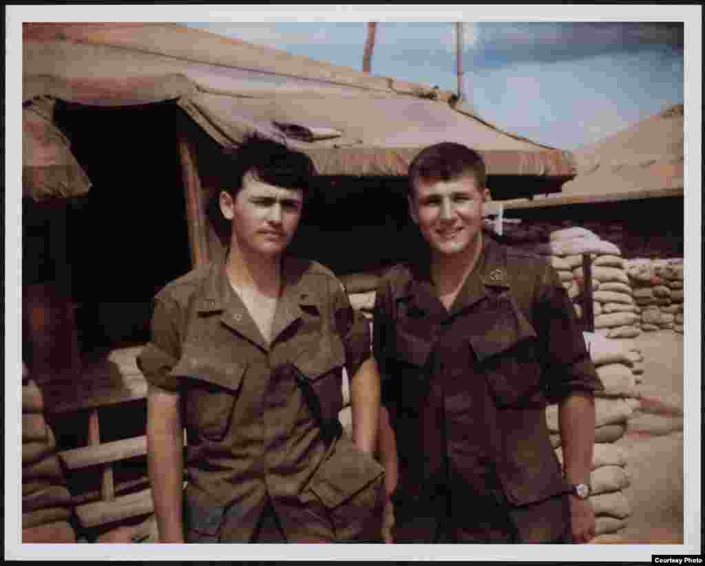 Chuck Hagel (right) standing outside tents in Vietnam, circa 1968. (Library of Congress)