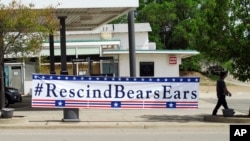 A banner sign hangs in Blanding, Utah, Monday, May 8, 2017, the day U.S. Interior Secretary Ryan Zinke toured Bears Ears National Monument on lands considered sacred by tribal groups.