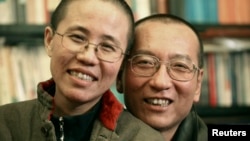 Chinese dissident Liu Xiaobo and his wife Liu Xia pose in this undated photo released by his family on October 3, 2010. 