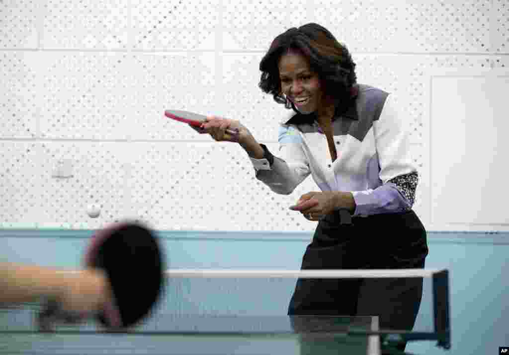 U.S. first lady Michelle Obama plays table tennis at the Beijing Normal School, a school that prepares students to attend colleges overseas, March 21, 2014.