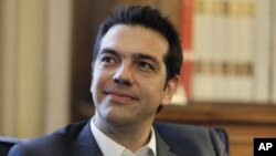 Greek leader of Coalition of the Radical Left party (SYRIZA) Alexis Tsipras looks on during a meeting with Greek President Karolos Papoulias, to formally take the mandate to form a coalition government in Athens. 