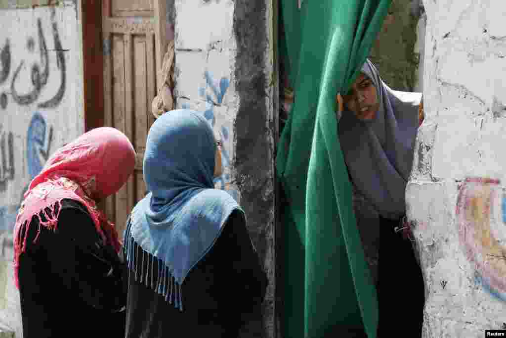 Palestinian women gather near the rubble of a building after what police said was an Israeli air strike at Shati refugee camp in Gaza City, Aug. 4, 2014.