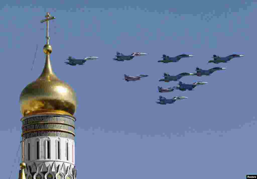 Russian military planes fly above the Kremlin, with the Ivan the Great Bell Tower seen in the foreground, during the Victory Day parade in Moscow's Red Square.