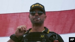FILE - In this Sept. 26, 2020, file photo, Proud Boys leader Henry "Enrique" Tarrio wears a hat that says The War Boys during a rally in Portland, Ore.