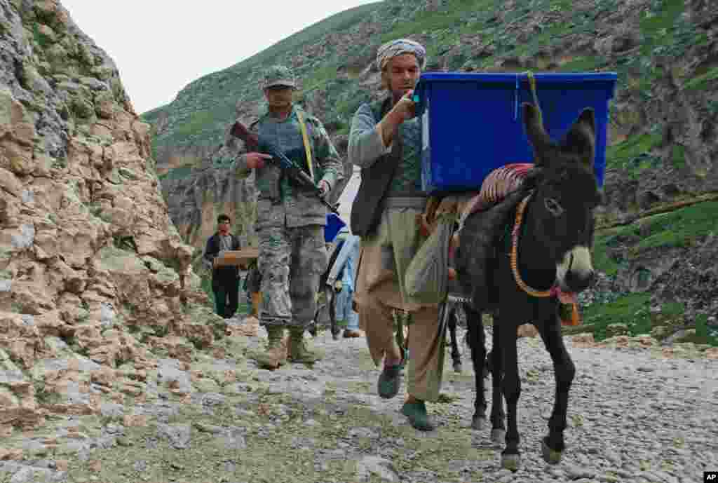 Petugas pemilu Afghanistan menggunakan keledai untuk mengangkut kartu-kartu suara pemilu dengan dikawal oleh tentara Afghanistan dari kota Mazar-i-Sharif ke Kishindih.