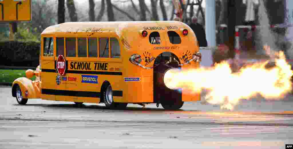Car designer Gerd Habermann launches his "School Bus Jet" vehicle during a preview of the Essen Motor Show in Essen, western Germany.