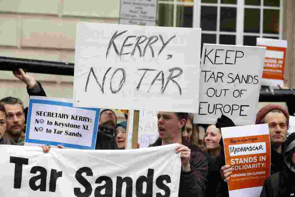 Protesters hold banners and placards during a demonstration near the G8 foreign ministers’ meeting in London, April 11, 2013.