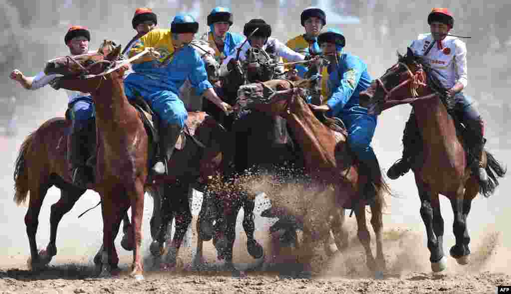 Russian (white) and Kazakh (blue) riders play the traditional Central Asian sport Buzkashi, also known as Kok-Boru or Oglak Tartis, during the World Nomad Games 2018 in Cholpon-Ata, Kirghizstan.