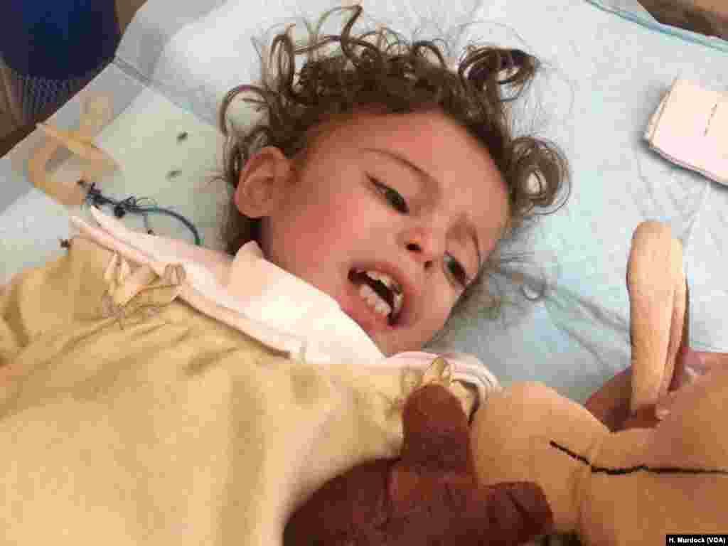 As doctors try to inject 1-year-old Saja with nutrients in the hours after her family fled IS territory in Mosul, Iraq, June 21, 2017, they say even in Iraqi-held areas of the city, children suffer wide-spread diarrhea and vomiting from dirty water.