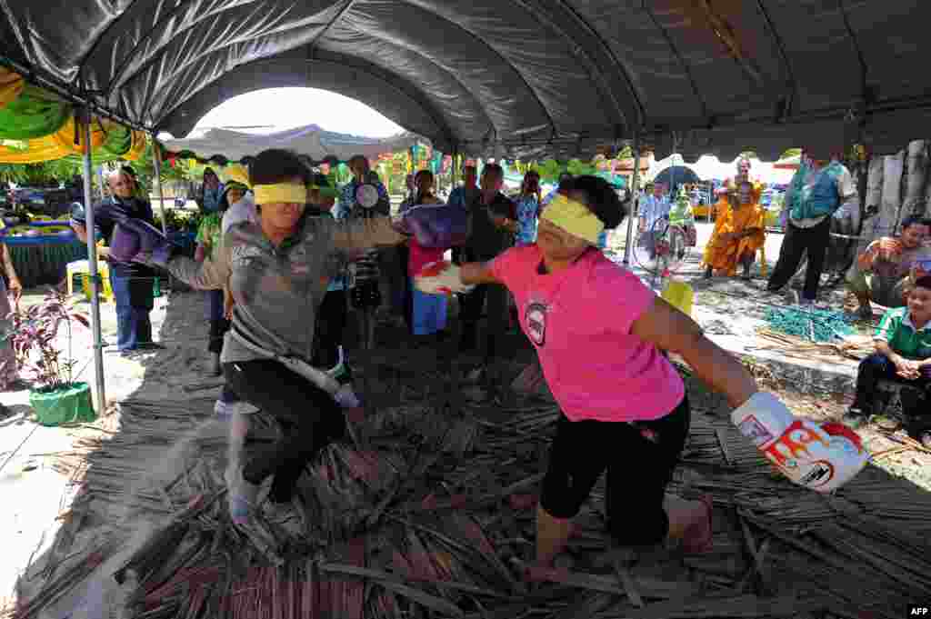 Thai Buddhist women take part in a blindfolded boxing bout as part of celebrations of the Songkran festival marking the Thai new year in Thailand's southern province of Narathiwat. The Thai new year falls on April 13. 