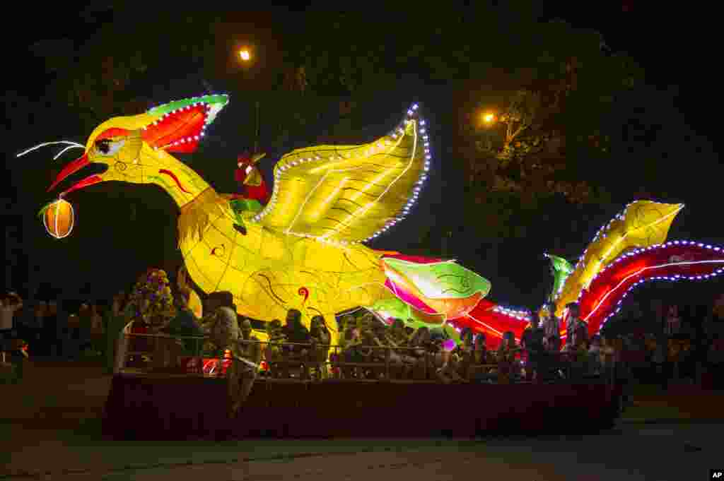 A phoenix lantern float parades through the streets to celebrate the Mid-Autumn, or Moon festival, in Tuyen Quang city, Vietnam, Oct. 2, 2017.