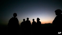  In this Sunday, Oct. 18, 2009 file photo, U.S. Army soldiers stand with Afghan policemen before a joint patrol of Qalanderkhail, outside of Bagram Air Field in Afghanistan. On Monday December 21, a suicide bomber killed six U.S. troops in an attack on a joint Afghan-NATO foot patrol on Monday. An attacker on a motorcycle rammed a group of troops as they patrolled a village near Bagram Airfield. (AP Photo/Maya Alleruzzo, File)