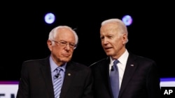 FILE - Democratic presidential candidates, Sen. Bernie Sanders, I-Vt., left, and former Vice President Joe Biden gesture during a Democratic presidential primary debate, Feb. 19, 2020, in Las Vegas, hosted by NBC News and MSNBC.