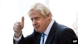 Britain's Prime Minister Boris Johnson gestures as he departs from Hudson Yards, in New York, Tuesday, Sept. 24, 2019.