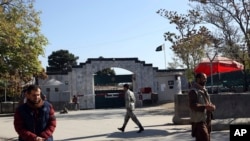 Security guards walk in front of the Pakistan Embassy in Kabul, Afghanistan, Nov. 4, 2019. 